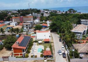 an aerial view of a city with buildings and the ocean at Flat do Golfinho in Tamandaré