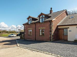 a brick house with a garage in a driveway at 5 Bed in Blackpool 40993 in Pilling