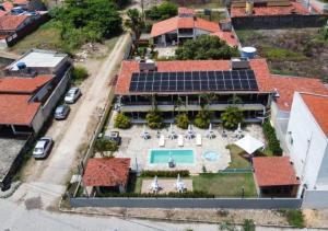 an aerial view of a house with solar panels on it at Flat do Golfinho in Tamandaré