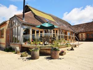 a building with a patio with an umbrella at 2 Bed in Dorchester 41364 in Ansty