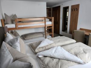 a group of pillows sitting on top of a bed at Bauernhof Waldegger in Nauders