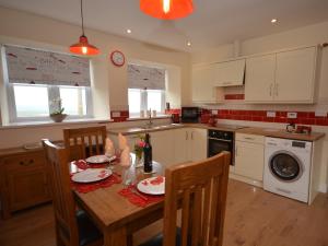 a kitchen with a table and chairs and a kitchen with a table and a sink at 1 Bed in Barnstaple 40352 in Chapelton