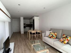 a living room with a couch and a table at Vivienda vacacional “Punta de la arena” in Breña Baja