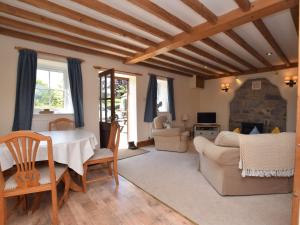 a living room with a table and a couch at 2 Bed in Ashford in the Water PK502 in Great Longstone