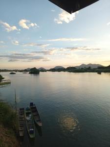 a group of boats sitting on the water at Sunset bar bungalows in Muang Không