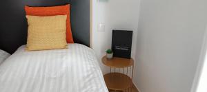 a small bedroom with a bed and a side table at Casa Ceedina Bed And Breakfast & Beauty in Batalha +31 photos