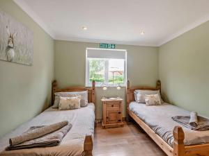 a bedroom with two beds and a window at 1 Bed in Brundall 46293 in Brundall