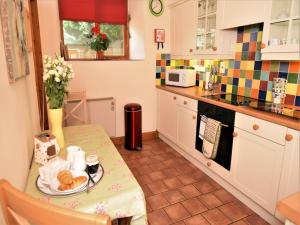 a kitchen with a table with a plate of food on it at 1 bed property in Banbury Cotswolds CC012 in Shotteswell