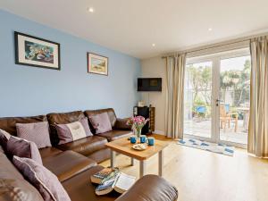 a living room with a couch and a table at 4 Bed in Bude 50591 in Bude