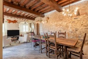 a dining room with a wooden table and chairs at La Capanna di Arturo Piano Terra in Capannori