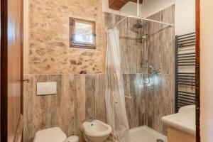 a bathroom with a shower and a toilet and a sink at La Capanna di Arturo Piano Terra in Capannori +17 photos