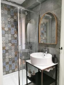 a bathroom with a sink and a shower at Unique City Centre Apartments in Nicosia