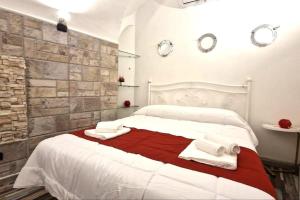 a bedroom with a large bed with towels on it at [Sea Front] - Welcoming Room in Mergellina in Naples
