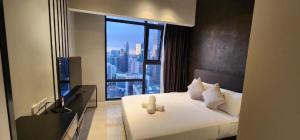 a hotel room with a bed with a large window at Axon Serviced Suites in Kuala Lumpur
