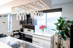 a kitchen with a sink and some chandeliers at Shinokubo guest house in Tokyo