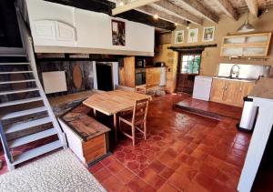 - une grande cuisine avec une table en bois dans l'établissement Maison de vacances 9 personnes avec piscine, à Saint-Amand-de-Coly