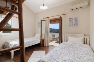 A bed or beds in a room at Villa Magnolia Corfu