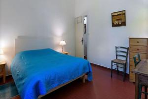 艾馬爾格的住宿－Château Teillan-Porte Italienne，一间卧室配有蓝色的床和椅子