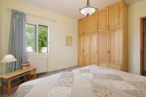 A bed or beds in a room at Villa Magnolia Corfu