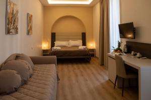 a living room with a couch and a bed at Palazzo Cappuccini Art Relais in Naples +87 photos