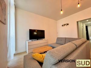 sala de estar con sofá y TV en Version Sud- Appartement moderne proche gare, en Toulon
