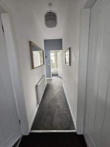 a hallway with white walls and a hallway with at Langley Park House, Durham in Langley Park