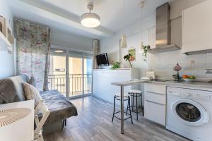 a kitchen and living room with a washing machine in a apartment at La Perla in Fuengirola