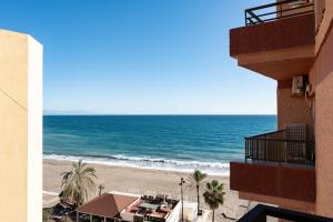 a view of the beach from the balcony of a hotel at La Perla in Fuengirola