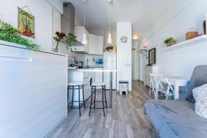 a kitchen and living room with a couch and a table at La Perla in Fuengirola +13 photos
