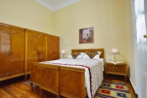 um quarto com uma cama de madeira e uma cómoda de madeira em The Place 3 charming downtown apartment no Cairo