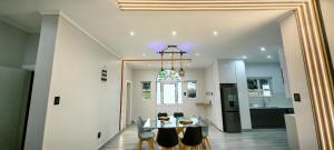 a dining room and kitchen with a table and chairs at Caribbean Estates Villa Varie - Luxury accommodation in Port Edward