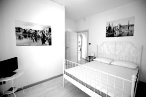 a black and white bedroom with a bed and a desk at TRA CIELO E MARE vista panoramica in Termoli