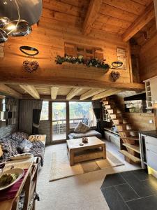 a living room with a staircase in a house at Chalet Flocon - luxury ski chalet by Avoriaz Chale in Avoriaz