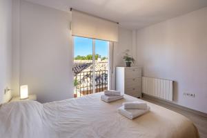 a bedroom with a large bed with two towels on it at Casa Mirador Alquería in Granada