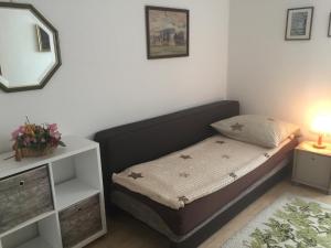 a small bedroom with a bed and a mirror at Ferienwohnung Eva Maria in Pforzheim