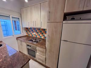 a kitchen with a refrigerator and a stove top oven at Amplio con Patio y vistas a la Plaza in Dolores