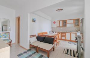 a living room with a table and a kitchen at Belvedere dole in Novigrad Istria