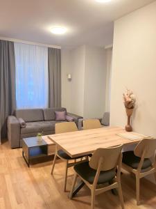 a living room with a table and a couch at SUNSKII Apartments in Brzeće