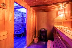 a sauna with a bench in a wooden room at Siedlisko Sobibór in Sobibór