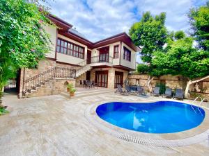 a house with a swimming pool and a patio at Attalos Villa in Antalya
