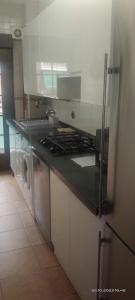 a kitchen with a stove and a counter top at Habitaciones individuales en apartamento turístico in Madrid