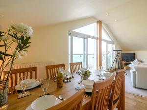 a dining room with a table with chairs and a large window at 2 Bed in Torquay 51143 in Torquay