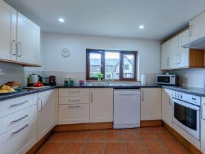 a kitchen with white appliances and a window at 2 Bed in Kinnerton CHL34 in Kinnerton