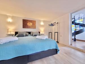 a large bedroom with a large bed with blue sheets at Miya del Sol Heated Saltwater Pool in La Orotava +66 photos