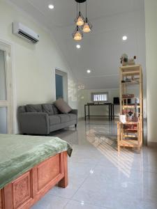 a living room with a couch and a table at Bếp Ông Tỏi Homestay in Ho Chi Minh City
