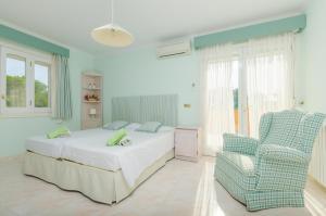 a bedroom with a bed and a chair at Casa Bonita (Ses Salines) in Ses Salines +55 photos