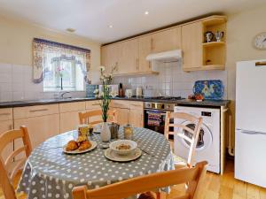 a kitchen with a table with food on it at 1 Bed in Nantgaredig 51499 in Llanfynydd