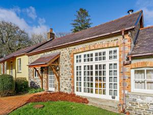 a brick house with a large window at 1 Bed in Nantgaredig 51499 in Llanfynydd