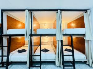 a couple of bunk beds in a room at Journey Hostel Haad Rin in Haad Rin