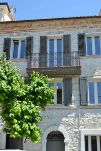 a building with a balcony and a tree in front of it at RAL 7039 in Numana